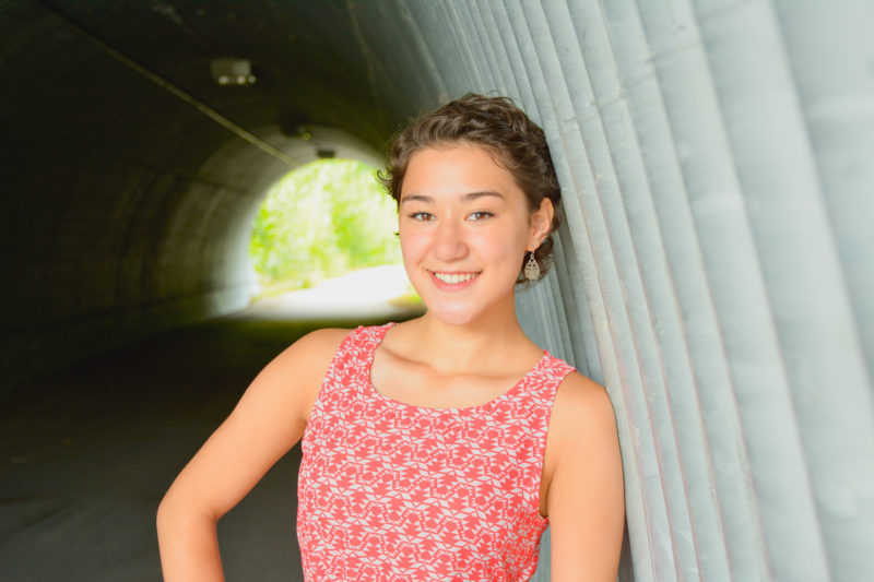 Asian senior girl portrait in an urban metal tunnel in Alaska.