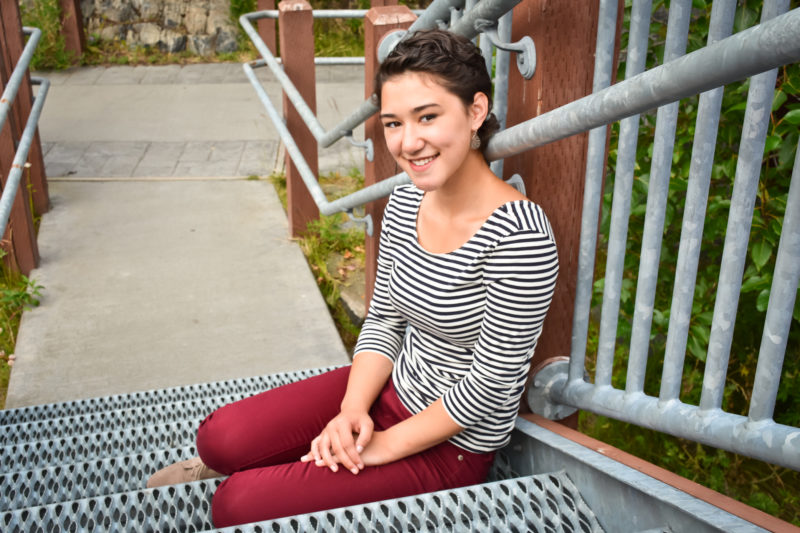 Asian senior girl portrait on metal stairs in Alaska.