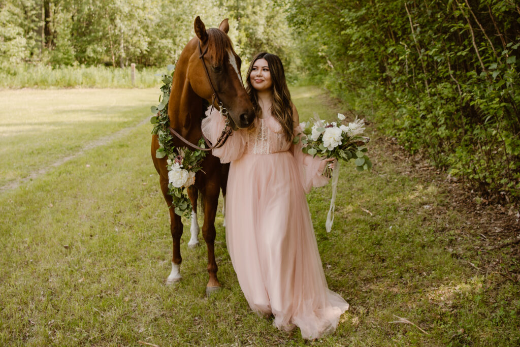 Bride with a horse in a green field